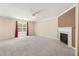 Inviting living room featuring carpeted floors, a fireplace, and ample natural light from a large window at 4205 Twin Spires Dr, Knightdale, NC 27545