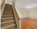 Staircase leading to an open dining room with hardwood floors and a chandelier at 4205 Twin Spires Dr, Knightdale, NC 27545