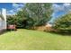 Large backyard boasts lush green grass and wooden fence, providing ample space and privacy at 432 Barn View Ct, Fuquay Varina, NC 27526