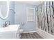 Bright bathroom features modern vanity, tub with shower, and contemporary finishes at 432 Barn View Ct, Fuquay Varina, NC 27526