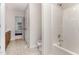 Bright bathroom featuring a bathtub, shower, and a door into another room at 432 Barn View Ct, Fuquay Varina, NC 27526