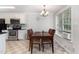 Dining area with a wooden table set, a window with natural light, and modern light fixture at 432 Barn View Ct, Fuquay Varina, NC 27526