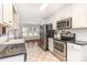 Well-lit kitchen with stainless steel appliances and view into the dining area at 432 Barn View Ct, Fuquay Varina, NC 27526