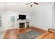 Bright living room showcasing a fireplace, hardwood floors, and a ceiling fan at 432 Barn View Ct, Fuquay Varina, NC 27526