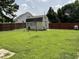 Well-maintained storage shed in a spacious, grassy backyard with fencing at 44 Glen Meadow Dr, Angier, NC 27501