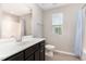 Bathroom featuring a single sink vanity and shower with blue striped curtain at 4505 Wingate Song Ct, Knightdale, NC 27545