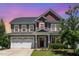 Charming two-story home boasts a manicured lawn and an inviting front entrance with a two-car garage at 4505 Wingate Song Ct, Knightdale, NC 27545