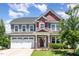 Charming two-story home boasts a manicured lawn and an inviting front entrance with a two-car garage at 4505 Wingate Song Ct, Knightdale, NC 27545