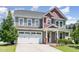 Charming two-story home boasts an inviting front entrance with brick accents and a manicured lawn at 4505 Wingate Song Ct, Knightdale, NC 27545