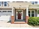 Inviting front door entrance with brick columns, white trim, and a 