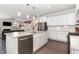 Open concept kitchen has a center island with granite countertops and flows into a living space at 4505 Wingate Song Ct, Knightdale, NC 27545