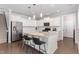 Bright kitchen features white cabinets, stainless steel appliances, and a large island with bar stool seating at 4505 Wingate Song Ct, Knightdale, NC 27545