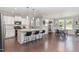 Open-concept kitchen with white cabinets, granite countertops, stainless steel appliances, and island seating at 4505 Wingate Song Ct, Knightdale, NC 27545