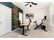 Modern office space featuring an adjustable desk and a Peloton bike at 4505 Wingate Song Ct, Knightdale, NC 27545
