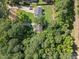Aerial view of a home surrounded by mature trees and a well-maintained lawn at 472 Shawnee Dr, Louisburg, NC 27549