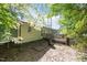 Backyard featuring a wooden deck and the tranquility of a wooded area, offering privacy and space at 472 Shawnee Dr, Louisburg, NC 27549