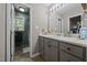 Bathroom featuring neutral tones, a vanity with storage, and a view to the bath and shower at 472 Shawnee Dr, Louisburg, NC 27549