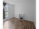 Bright bedroom featuring wood-look floors, a window, and a small shelving unit at 472 Shawnee Dr, Louisburg, NC 27549