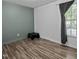 Clean bedroom with neutral colors, hardwood flooring, and a bright window at 472 Shawnee Dr, Louisburg, NC 27549