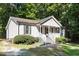 Beautiful home with a welcoming front porch and classic siding, nestled in a wooded lot at 472 Shawnee Dr, Louisburg, NC 27549