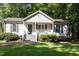 Charming home featuring a quaint front porch, neutral siding, and lush green lawn at 472 Shawnee Dr, Louisburg, NC 27549