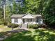 Delightful home exterior showcasing a well-maintained lawn, classic design, and a cozy front porch for relaxing at 472 Shawnee Dr, Louisburg, NC 27549