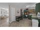Eat-in kitchen with green cabinetry, stainless appliances, and tile flooring at 472 Shawnee Dr, Louisburg, NC 27549
