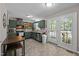 Kitchen with green cabinetry, granite countertops, stainless appliances, and access to the rear deck at 472 Shawnee Dr, Louisburg, NC 27549