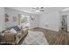 Neutral living room with wood-look floors, comfortable sofa, and ample natural light at 472 Shawnee Dr, Louisburg, NC 27549