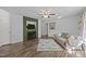 Living room with green accent wall, fireplace, wood-look floors, and comfortable seating at 472 Shawnee Dr, Louisburg, NC 27549