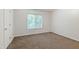 Cozy bedroom with carpet flooring, a window for natural light, and a closet at 4802 Parkville Dr, Raleigh, NC 27604