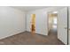 Bedroom with neutral paint, carpet flooring, and bathroom and closet access at 4802 Parkville Dr, Raleigh, NC 27604