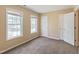 Bedroom with neutral walls and carpeting featuring lots of sunlight through two windows at 4802 Parkville Dr, Raleigh, NC 27604