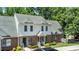 Townhome with brick and vinyl siding with a well maintained lawn and plants at 4802 Parkville Dr, Raleigh, NC 27604