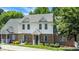 Two story townhome featuring brick and vinyl siding, well-maintained landscaping, and a green front yard at 4802 Parkville Dr, Raleigh, NC 27604
