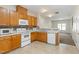 Functional kitchen with wood cabinets, white appliances, and tile backsplash at 4802 Parkville Dr, Raleigh, NC 27604