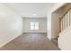 Spacious living room with carpet flooring, neutral walls, and a staircase to the second level at 4802 Parkville Dr, Raleigh, NC 27604