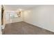 View of open living area leading to the kitchen, carpet floors, and lots of natural light at 4802 Parkville Dr, Raleigh, NC 27604