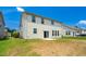 The backyard features a concrete patio and a 2 story vinyl clad home at 517 Eagles Way, Mebane, NC 27302