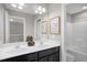 A clean double vanity bathroom features modern fixtures, art and pristine white bathtub at 517 Eagles Way, Mebane, NC 27302