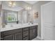 Bathroom featuring a double sink vanity with dark cabinets and a large mirror with modern lighting at 517 Eagles Way, Mebane, NC 27302