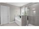 Modern bathroom featuring a tub, shower, and a window, all designed for comfort and relaxation at 517 Eagles Way, Mebane, NC 27302