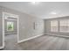 Neutral bedroom with carpet flooring, two windows providing natural light, and a doorway to another room at 517 Eagles Way, Mebane, NC 27302