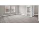 Spacious bedroom showcasing plush carpeting and a view into another room through a doorway at 517 Eagles Way, Mebane, NC 27302