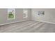 Bedroom with carpet flooring and two windows offering bright, natural light and pleasant views at 517 Eagles Way, Mebane, NC 27302
