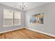 A dining room featuring hardwood floors, neutral paint, natural light, and decorative artwork at 517 Eagles Way, Mebane, NC 27302