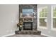 Stone fireplace with a decorative mantle in a well-lit living room at 517 Eagles Way, Mebane, NC 27302