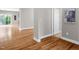 View of the hallway featuring hardwood floors, neutral paint, white trim, and natural light at 517 Eagles Way, Mebane, NC 27302