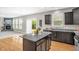 Kitchen with a center island, dark cabinets, granite countertops, and an open layout at 517 Eagles Way, Mebane, NC 27302