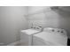 A laundry room features full size white appliances and a wire rack at 517 Eagles Way, Mebane, NC 27302
